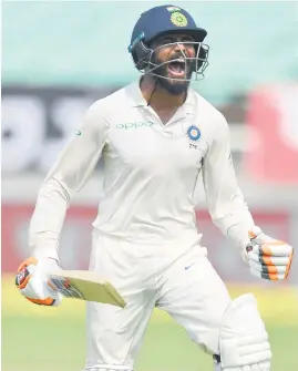  ?? Picture: AFP ?? PILING ON THE MISERY. India’s Ravindra Jadeja celebrates after reaching his century during the second day of the first Test against the West Indies in Rajkot yesterday.