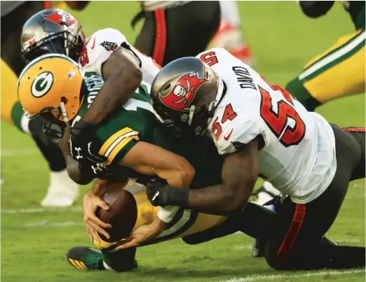  ?? MIKE EHRMANN/GETTY IMAGES ?? Jason Pierre-Paul and Lavonte David sack Packers quarterbac­k Aaron Rodgers during the third quarter Sunday in Tampa, Fla.