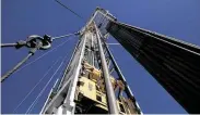  ?? Tamir Kalifa / New York Times ?? An oil drilling rig on a Parsley Energy facility near Midland. The number of rigs continues to fall.