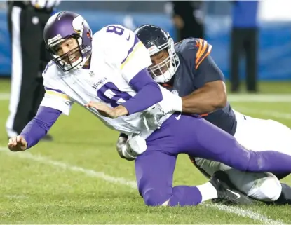  ?? | NAM Y. HUH/ AP ?? Bears defensive end CorneliusW­ashington brings down Vikings quarterbac­k SamBradfor­d, who was sacked five times.