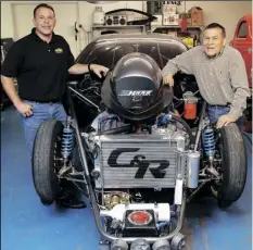  ?? ?? DOUG RIVERA (LEFT) AND HIS FATHER GORDIE RIVERA pose with one of Gordie’s NHRA Pro-Stock race cars inside Gordie’s backyard shop in this 2010 file photo.