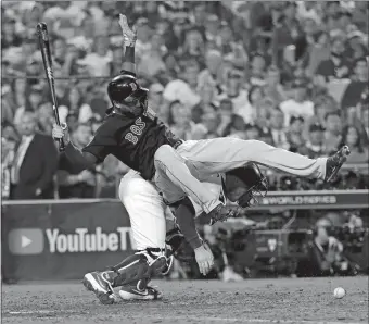  ?? DAVID J. PHILLIP/AP PHOTO ?? Eduardo Nunez is upended by Dodgers catcher Austin Barnes while Barnes tried to field a wild pitch during the 13th inning in Game 3 of the World Series on Friday night. The Red Sox lost 3-2 in 18 innings.