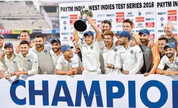  ?? PIC/PTI ?? Indian cricket team players poses with the winning trophy after beating West Indies in the second test match, in Hyderabad, on Sunday