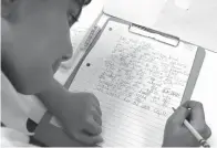  ??  ?? above
■ Good Shepherd Episcopal School third-grader Ahan Jain writes to his pen pal Nancy Miller, a resident at Presbyteri­an
Village North, on March 19 in Dallas.