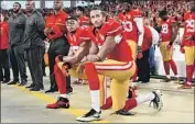  ?? Thearon W. Henderson Getty Images ?? COLIN KAEPERNICK, foreground, and Eric Reid kneel during the national anthem before a 2016 game.