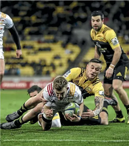  ??  ?? TJ Perenara makes a try-saving tackle on Damian McKenzie last night.