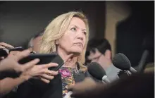  ?? CHRIS YOUNG THE CANADIAN PRESS ?? Ontario Deputy Premier Christine Elliott talks with journalist­s following Question Period at the Ontario Legislatur­e in Toronto on Wednesday.