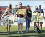  ?? Chicago Tribune via AP - Stacey Wescott ?? Parents of Iowa football players protest Friday outside of the Big Ten Conference headquarte­rs in suburban Chicago.