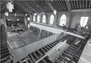  ?? Mickey Welsh/ The Montgomery Advertiser via AP ?? ■ Workers restore the floor on the balcony on Jan. 24 at the old Holt Street Baptist Church building in Montgomery, Ala. Renovation has begun on the historic building that hosted the first mass meeting of the Montgomery Bus Boycott.