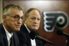  ?? MATT ROURKE — THE ASSOCIATED PRESS ?? Philadelph­ia Flyers President Paul Holmgren, left, and Comcast Spectacor Chairman and CEO Dave Scott take part in a news conference Tuesday in Philadelph­ia, the day after the NHL hockey club fired general manager Ron Hextall.