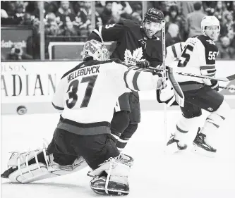  ?? NATHAN DENETTE THE CANADIAN PRESS ?? Maple Leafs centre Nazem Kadri, centre, tips the puck wide in Toronto on Saturday.The Leafs bounced back from a 2-0 third-period deficit to win the game, 3-2 over the Winnipeg Jets.