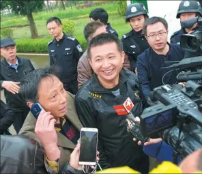  ?? PROVIDED TO CHINA DAILY ?? Chen Man (center) speaks to the media after his conviction was overturned.
