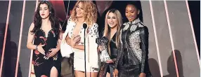  ??  ?? From left: Lauren Jauregui, Dinah Jane, Ally Brooke and Normani Kordei of Fifth Harmony accept the award for Best Fan Army at the iHeartRadi­o Music Awards at the Forum recently in Inglewood, California.