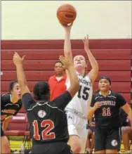  ?? PETE BANNAN — DIGITAL FIRST MEDIA ?? WC Rustin’s Erin Gallagher (15) puts a shot over Coatesvill­e’s Olivia Ellzy (12) in the first half Friday.