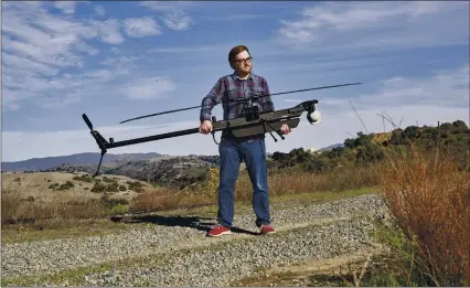  ?? PHILIP CHEUNG — THE NEW YORK TIMES ?? Brian Schimpf, chief executive of Anduril, holds a Ghost drone at a testing area near Camp Pendleton. Although much has been made of Silicon Valley’s unwillingn­ess to work with the Pentagon, start-ups are still plumbing the industry’s decades-long ties to the military.