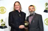  ??  ?? Danny Carey (left) and Justin Chancellor of Tool, pose in the press room with the award for Best Metal Performanc­e for ‘7empest’.