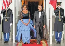  ??  ?? From left: Michelle Obama’s evening dress for a State Dinner;Michelle in a Marchesa gown — a custom version from the Marchesa Fall 2013 collection; she wears the same shirtdress she’d worn to lunch with Katy Perry in 2012.