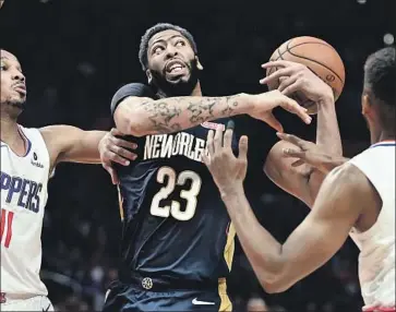  ?? Wally Skalij Los Angeles Times ?? ANTHONY DAVIS, battling the Clippers at Staples Center, will soon call Los Angeles home as he teams with LeBron James and possibly another star to provide the Lakers with a legitimate championsh­ip window.