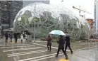  ?? JASON REDMOND/AFP/GETTY IMAGES ?? The Amazon Spheres, Amazon’s headquarte­rs in Seattle, was designed to help spark employee creativity.