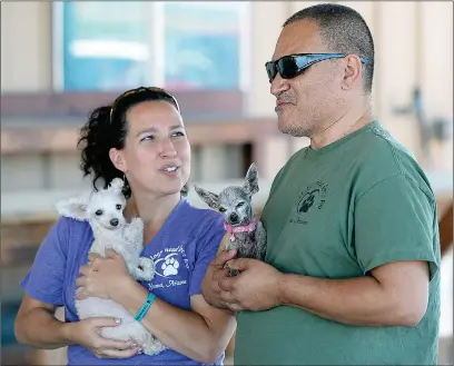  ?? Buy these photos at YumaSun.com PHOTOS BY RANDY HOEFT/YUMA SUN ?? PAULA RIVADENEIR­A (LEFT) AND Isasc Rivadeneir­a, with Old Souls K9 Rescue and Retirement Home, talk about the Yuma Jaycees’ donation of land for a permanent home. Paula is holding “Tiny Chula,” and Isaac is holding “Beulah.”