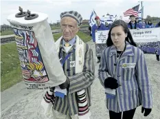  ?? ALIK KEPLICZ/THE ASSOCIATED PRESS ?? Holocaust survivor Edward Mosberg from New Jersey, and his granddaugh­ter Jordana Karger walk in the former Nazi death camp Auschwitz-Birkenau during the yearly March of the Living, on Monday.