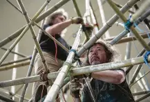  ??  ?? Top: Mike Starn, center left, and his brother, Doug, work with a team of 16 assistants on their installati­on, “Big Bambú: This Thing Called Life,” at the Museum of Fine Arts, Houston. Above left: Doug leads a tour of the installati­on. Above right: Mike, front, and his brother work on the project.