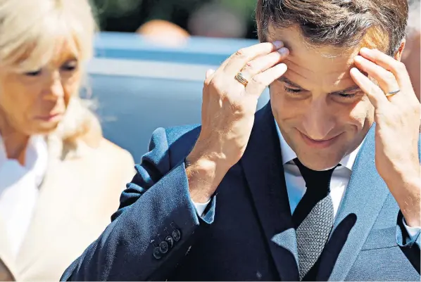  ?? ?? Emmanuel Macron, the French president, and his wife, Brigitte, arrived to vote at a polling station in Le Touquet, northern France, but early indication­s were that he would be facing a headache