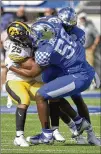  ?? PHELAN M. EBENHACK/ASSOCIATED PRESS ?? Iowa running back Gavin Williams is stopped by Kentucky’s D’Eryk Jackson and Jordan Wright after a catch.