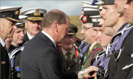 ??  ?? In Rosslare Harbour, Minister of State with special responsibi­lity for Defence, Paul Kehoe, presents the new internatio­nal operationa­l service medals to troops who were deployed to counter the Ebola crisis in Sierra Leone and naval personnel who helped...