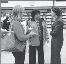  ?? Photo by Kendra Lolio ?? Governor Gina Raimondo talks to teachers Christine Kirch and Kerry Martinelli after the public forum Monday.