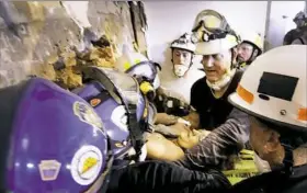  ?? Michael Haritan/PEMA ?? Rescue workers attempt to extract Megan Angelone from a collapsed building through an 18-inch hole cut Wednesday at a former coffee shop next to the building in Washington, Pa.