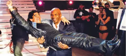  ?? LDP IMAGES PHOTO ?? Mike Tyson prepares to take soccer-player-turned- TV-chat-show-host Diego Maradona back to the green room to nibble on his ears. Tyson was guesting on the last of Maradona’s 13-episode show La Noche del Diez The Night of Number 10, ( his jersey number)...