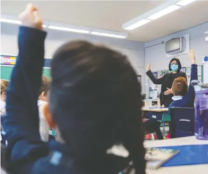  ?? DAVE SIDAWAY ?? The English Montreal School Board showed off its new air purifiers at Pierre Elliott Trudeau Elementary School on Monday. The HEPA filter, which the Quebec government believes is not necessary, hangs from the wall in the background while principal Tanya Alvarez takes over a class.