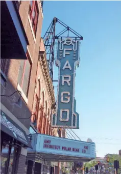  ?? — WP-Bloomberg photos ?? The restored art deco Fargo Theatre sits on a downtown strip of old and new: A uniform store, VFW, fancy oil shop and yoga studio.