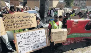  ?? Picture: LULAMILE FENI ?? EMPLOYMENT DISPUTE: Roads and public works department contract workers marched to the Mthatha regional office demanding to be absorbed by the department as permanent employees
