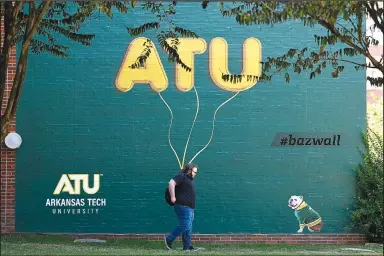  ?? (Arkansas Democrat-Gazette/Stephen Swofford) ?? A student walks past a mural on the Arkansas Tech University campus in Russellvil­le on Wednesday.