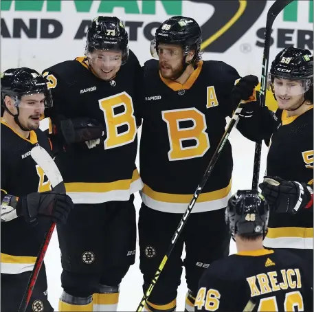  ?? MICHAEL DWYER — THE ASSOCIATED PRESS ?? New Bruins forward Tyler Bertuzzi (59) celebrates a goal with. from left, Dmitry Orlov, Charlie McAvoy, David Pastrnak and David Krejci in a 4-2 victory over the New York Rangers.