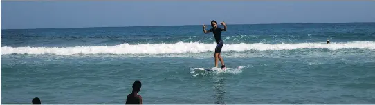  ?? PHOTOS: RENÉ BRUEMMER ?? The Haiti Surf school, east of the seaside resort town of Jacmel, offers tourists the chance to catch some waves with the help of friendly local instructor­s.