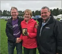  ??  ?? Mairead McGuinness, MEP for Sligo and first Vice-President of the European Parliament who officially opened Sligo Agricultur­al Show on Saturday is presented with a turf footing trophy by Harry King watched by Show Chairman, Michael Harte.