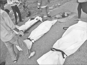  ??  ?? The three bodies after being extricated from the wrecked van.