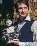  ??  ?? Piotr Mirowski poses with his toy robot, A.L.Ex.