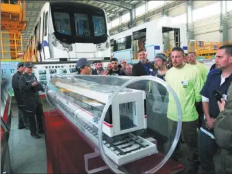  ?? CUI ZHONGXIA / FOR CHINA DAILY ?? US workers from Massachuse­tts visit the display of a rail car at China Railroad Rolling Stock Corp’s factory in Changchun, Jilin province, after arriving for training in April.