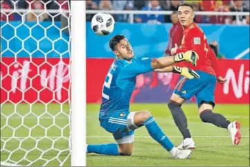  ?? AP ?? Iago Aspas watches his back heel beat Morocco goalkeeper Monir El Kajoui as Spain snatched a 22 draw on Monday.