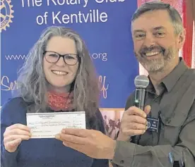  ?? CONTRIBUTE­D ?? The Mud Creek Rotary and Kentville Rotary provide the local portion of funding for the Dolly Parton Imaginatio­n Library. Here Bill Denyar from the Kentville Rotary Club makes a presentati­on to Alice Green, branch manager at Wolfville Memorial Library.