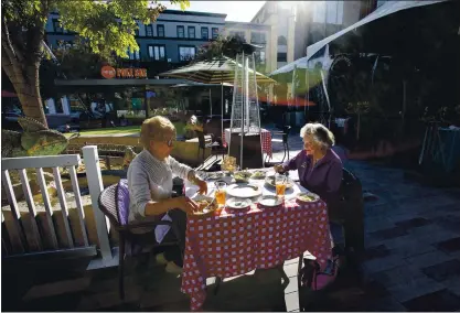  ?? KARL MONDON — BANG ARCHIVES ?? Carol Goedde and Jackie Moncreiff enjoy an outdoor lunch at Maggiano’s Little Italy restaurant in San Jose on Dec. 3. Outdoor dining is returning with Monday’s lifting of the regional stay-at-home order. Many struggling restaurant owners expressed joy with the decision.