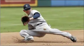  ?? BRANDON WADE—THE ASSOCIATED PRESS ?? New York Yankees third baseman Brent Lillibridg­e fields a hit by Texas Rangers’ Adrian Beltre in the fourth inning on Thursday. Lillibridg­e would throw to first for the out.