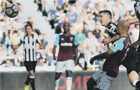  ??  ?? Newcastle defender Ciaran Clark heads home the vital second goal in Saturday’s defeat of West Ham.