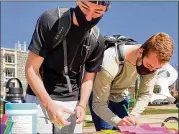  ?? CONTRIBUTE­D ?? Georgia Tech students sign notes about their feelings during a wellness event. Tech opened a mental health office on campus a few months before the pandemic and has seen more follow-up appointmen­ts.