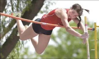  ?? / Staff Photograph­er ?? Olivia Kosanovich, of Fairview, clears the bar during Thursday’s pole vault event at the state track and field championsh­ips in Lakewood.