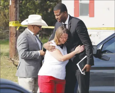  ?? AP PHOTO ?? Pastor Dimas Salaberrio­s, right, prays with Sherri Pomeroy near the First Baptist Church of Sutherland Springs, Monday, Nov. 6, 2017, in Sutherland Springs, Texas.